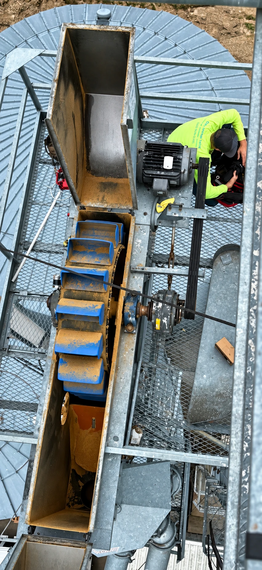Technician inspecting grain handling equipment